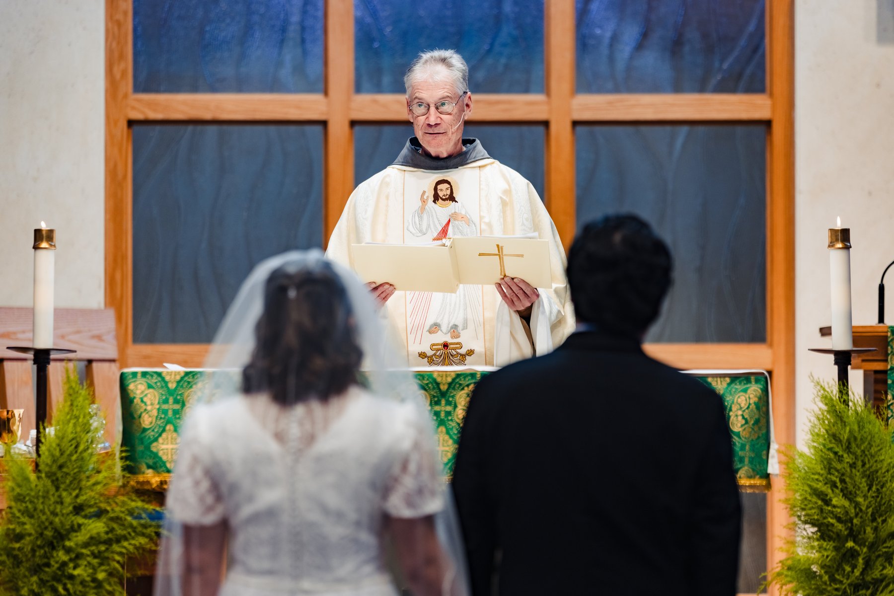 The priest proclaims the Gospel in a Divine Mercy chasuble at a Catholic wedding in Hermosa Beach
