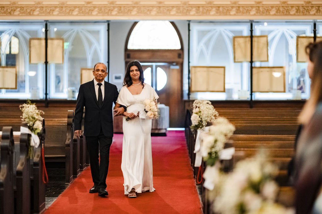 Bride enters Old St. Mary's Cathedral with her father at the start of the Nuptial Mass
