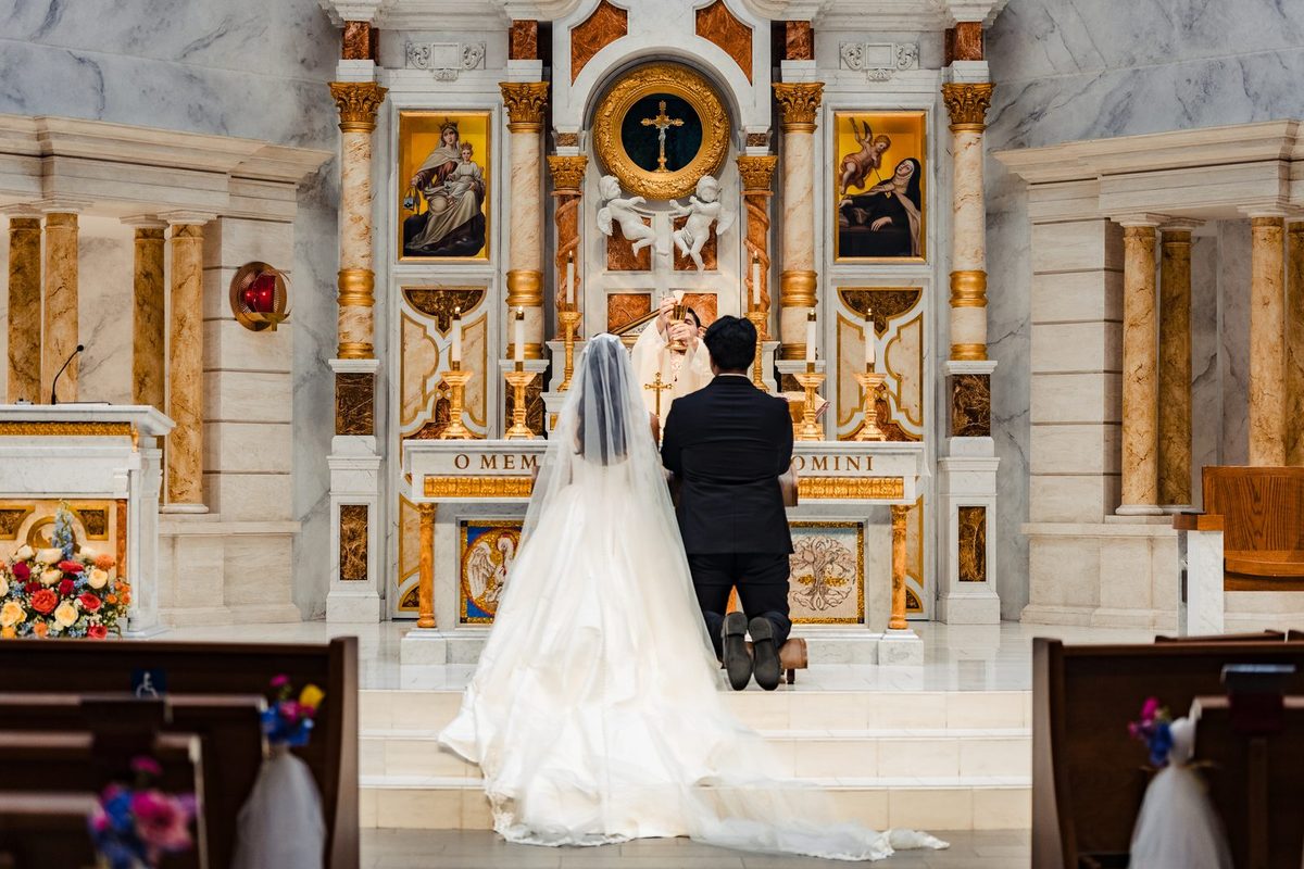 A catechist-priest elevates the consecrated Host at a Neocatechumenal Way wedding
