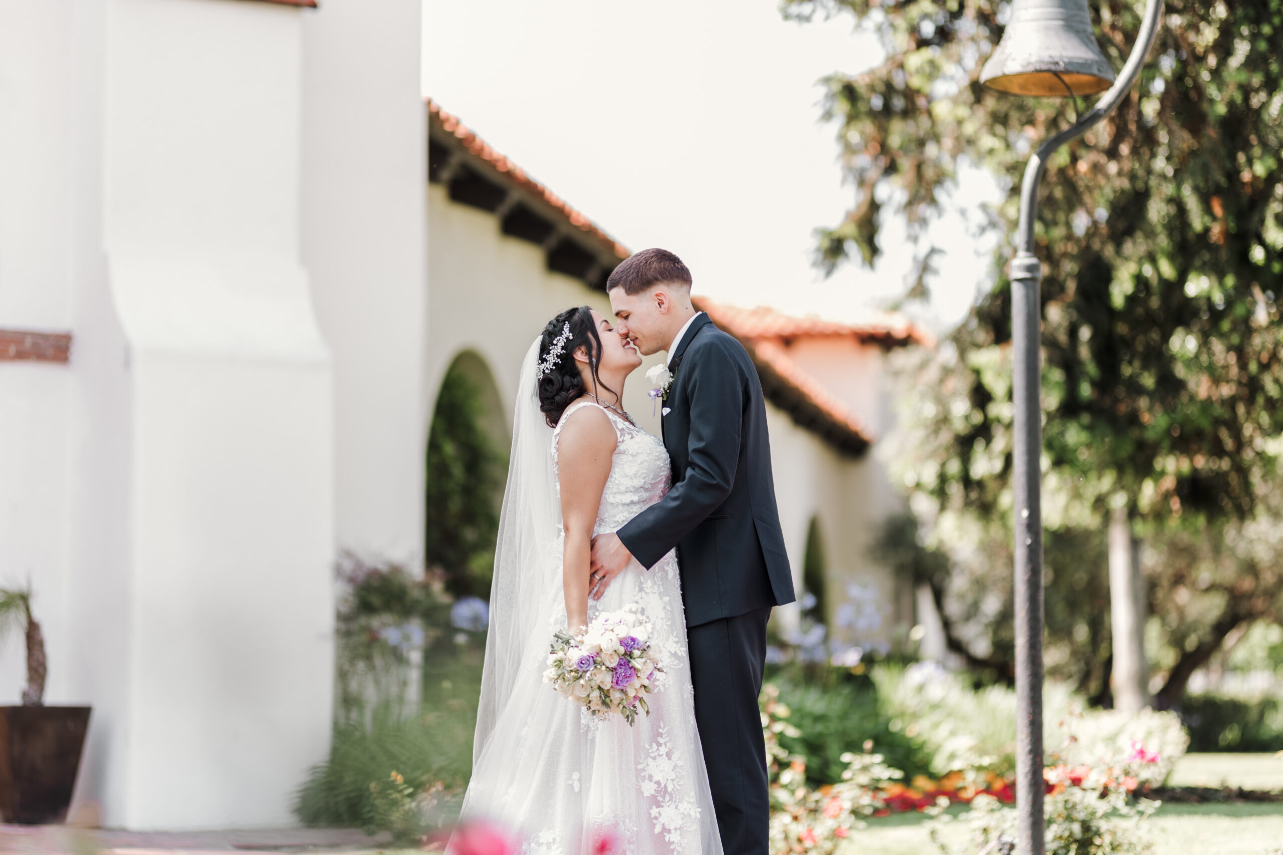 Newlyweds share a kiss at Bowers Museum in Santa Ana Ca