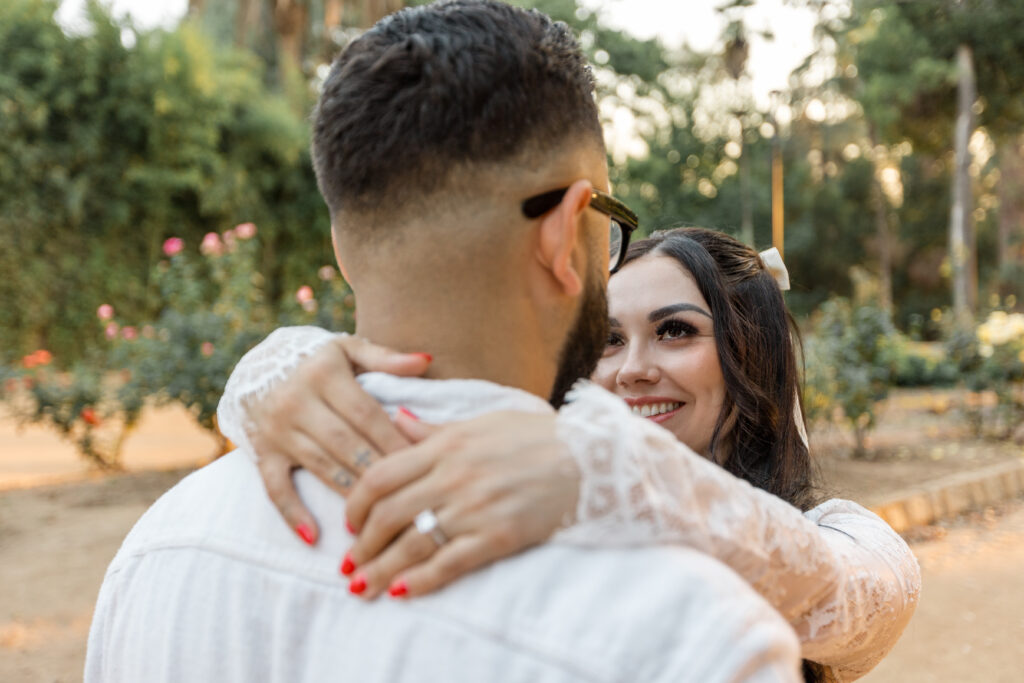 Fiance looking into eyes at Prospect park in Redlands