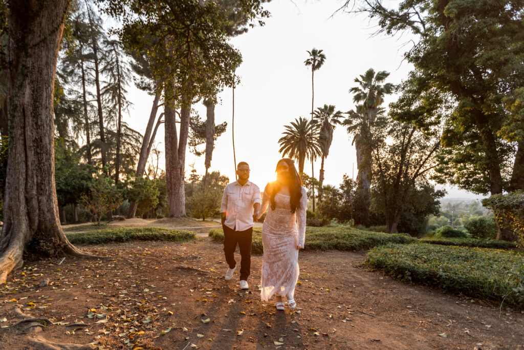 Couple walking pathway at Prospect Park in Redlands during sunset