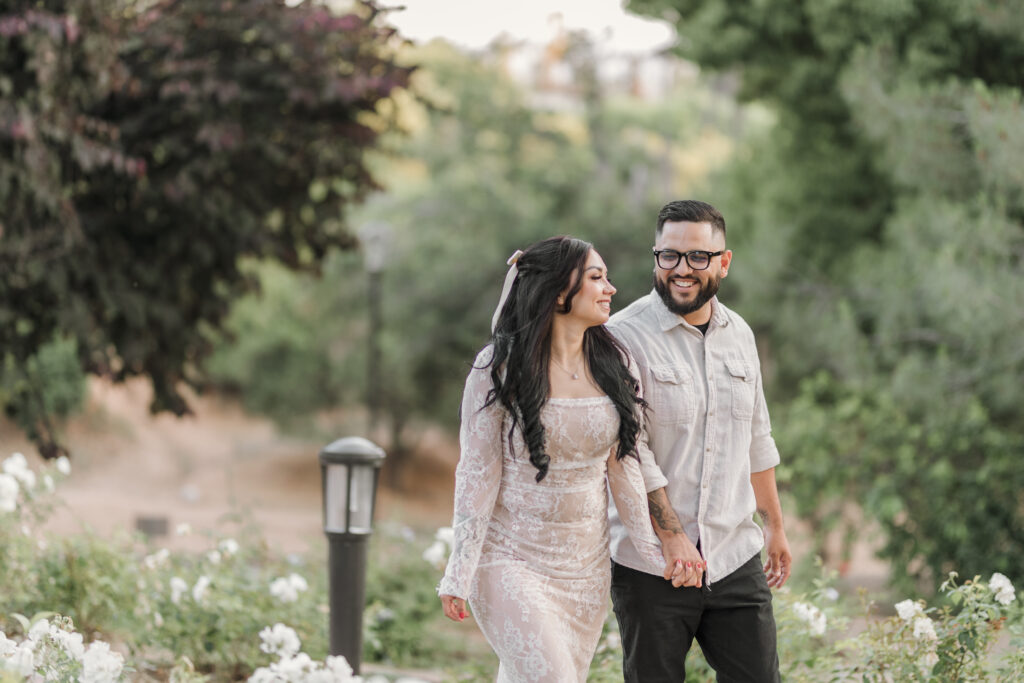 Couple holding hands and walking pathway at Redlands Prospect Park