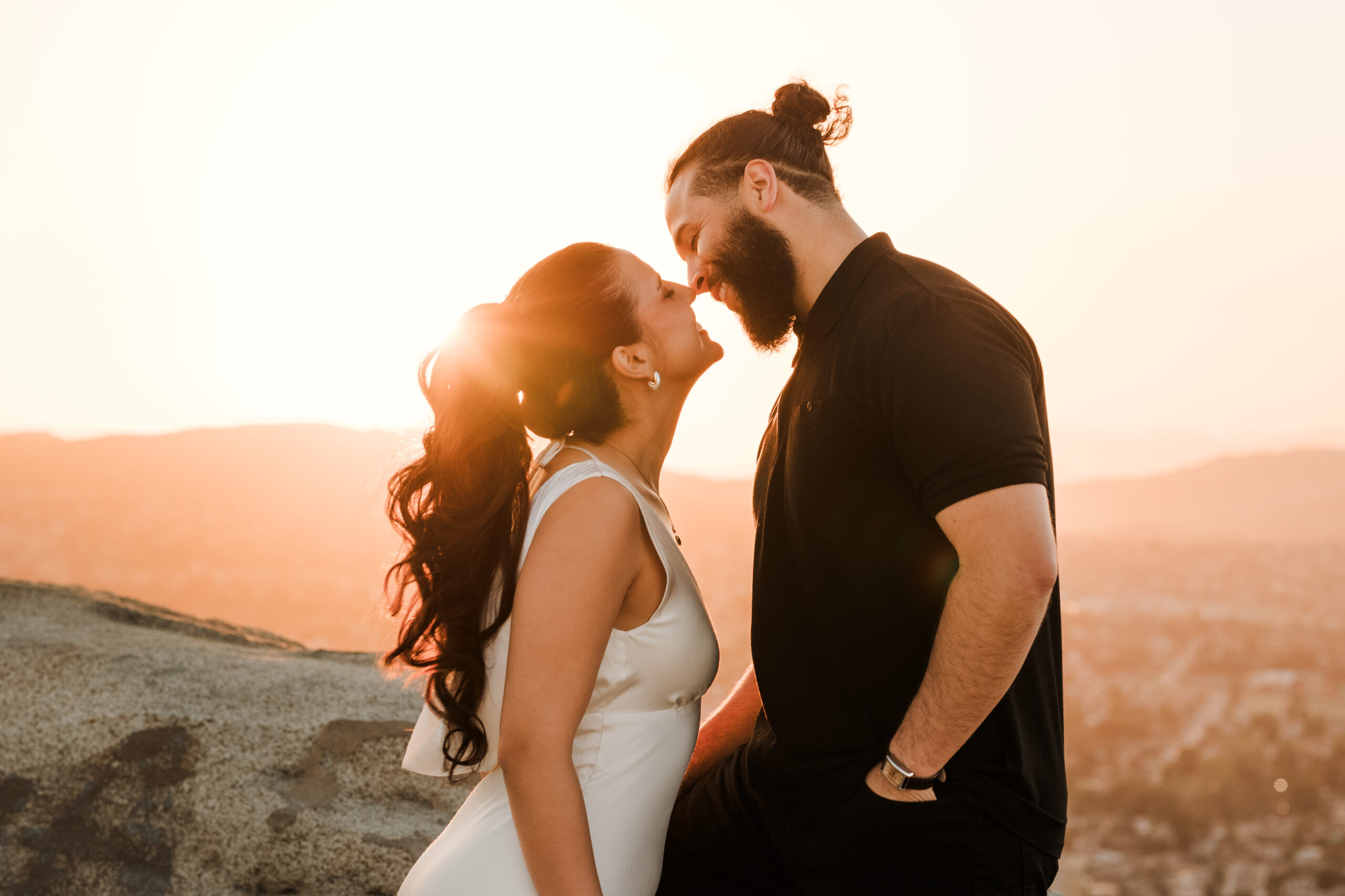 Engagement session during sunset on top of Mount Rubideaux over looking riverside county
