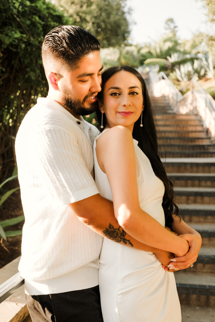 Couple holding each other at staircase at Treasure Island Laguna Beach