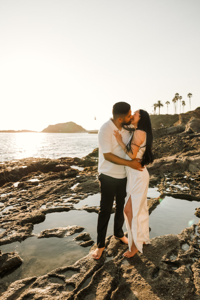 Couple kissing during sunset on shore of Laguna Beach