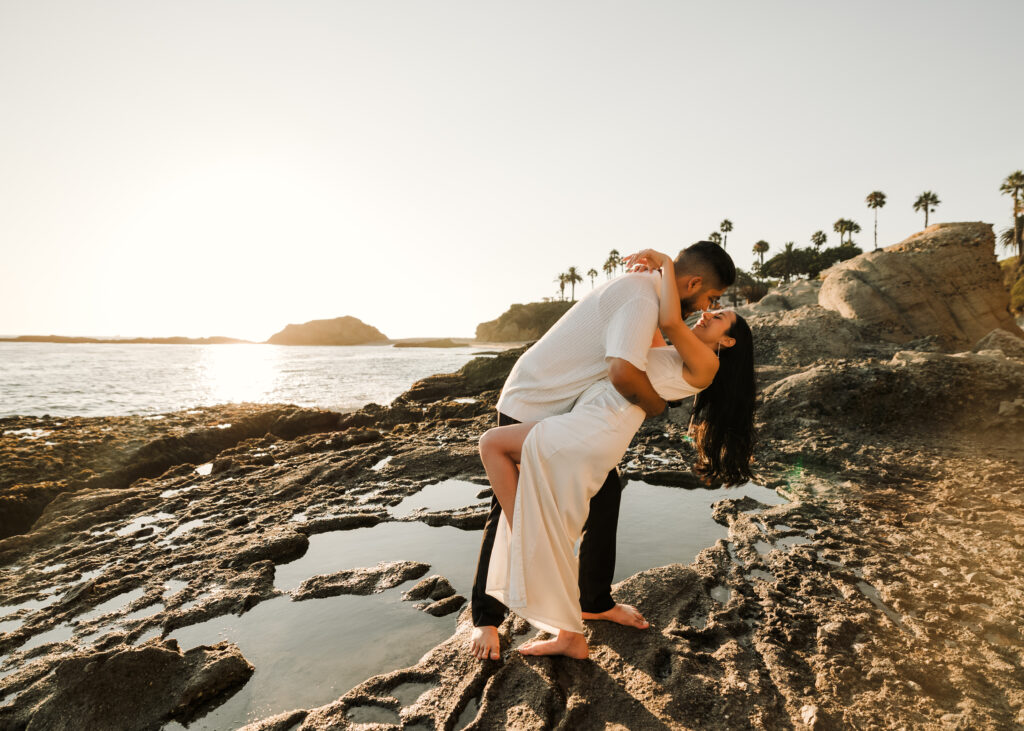 Couple engaged in a kiss during sunset on Laguna Beach Shore