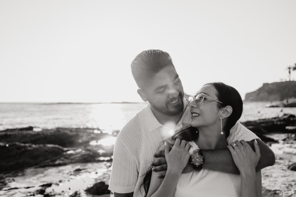 Black and white portrait at sunset of engaged couple in Laguna Beach