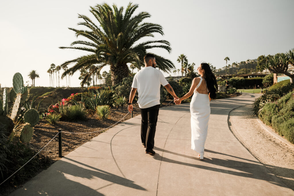 Couple walking holding hands at Treasure Island Laguna Beach