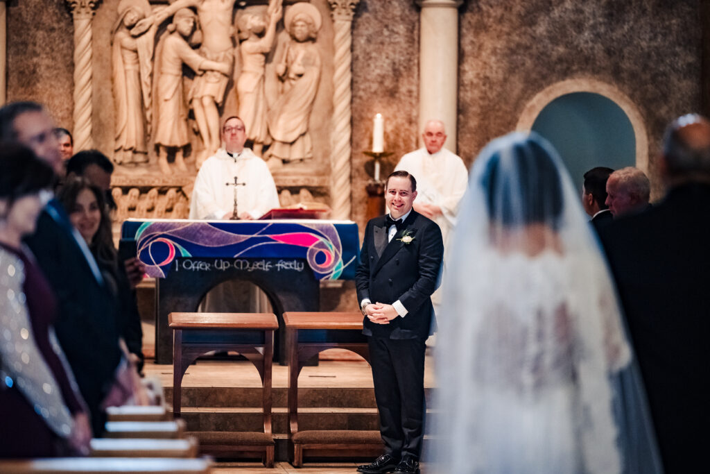 Groom watching his Bride walk down the Aisle at Saint Martha's Catholic Parish in Murrieta Ca