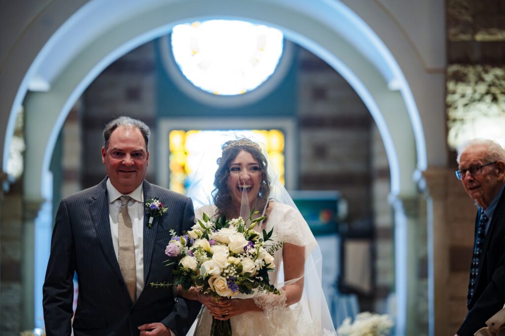 bride walking down the aisle at St Martha's Catholic Parish in Murrieta Ca