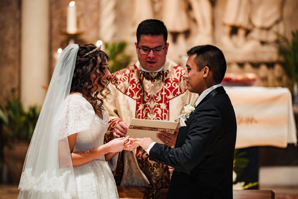 Bride and Groom exchanging vows at St Martha's Catholic Parish in Murrieta Ca