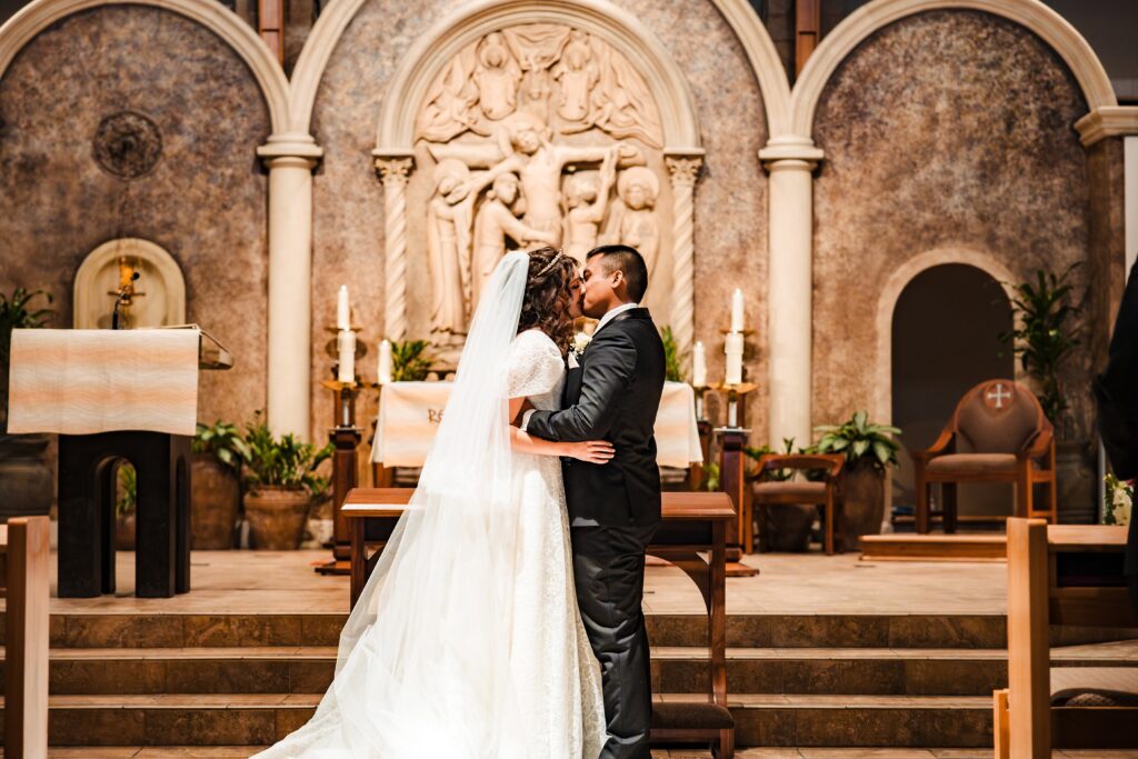Husband and Wife's first kiss at St Martha's Catholic Parish in Murrieta Ca