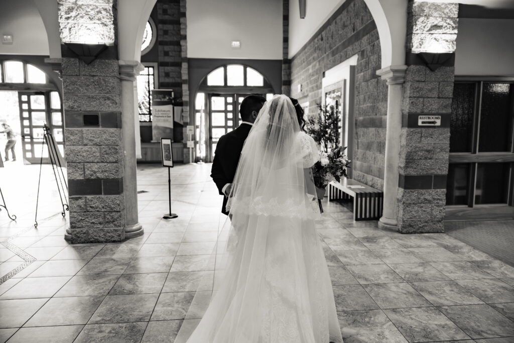 Husband and wife exiting wedding mass at St Martha's Catholic Parish in Murrieta Ca