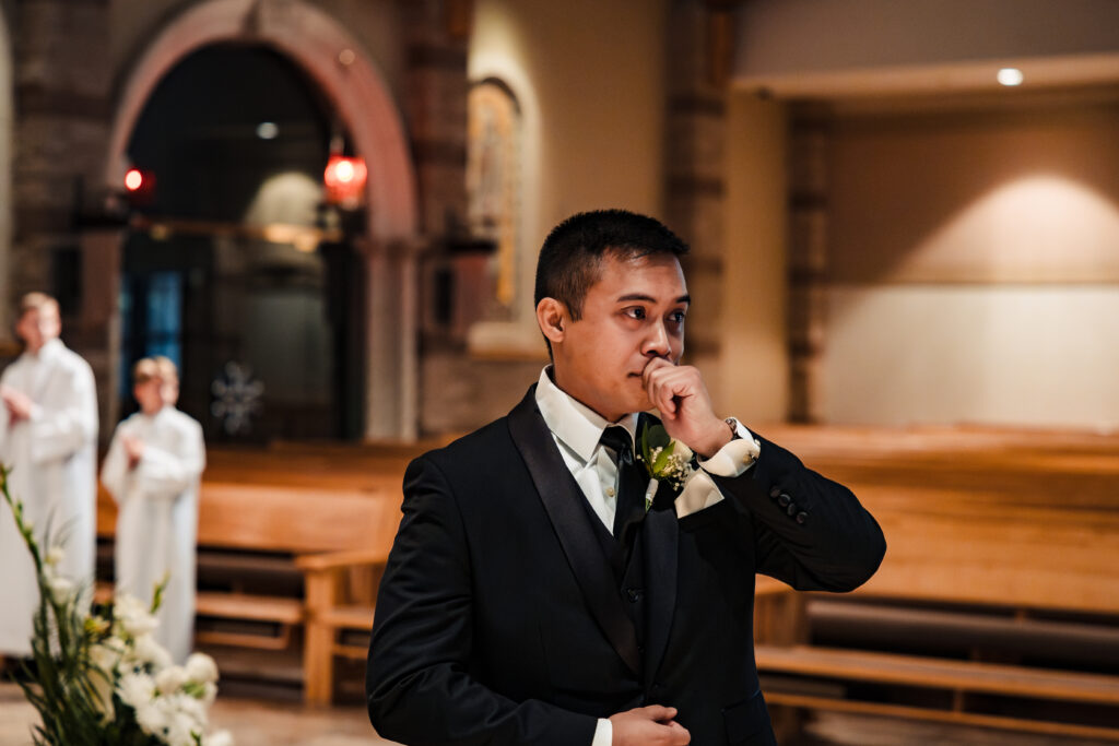 Groom seeing his bride walking down the aisle at St Martha's Catholic Parish in Murrieta Ca