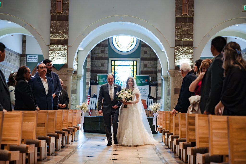 bride walking down the aisle at St Martha's Catholic Parish in Murrieta Ca
