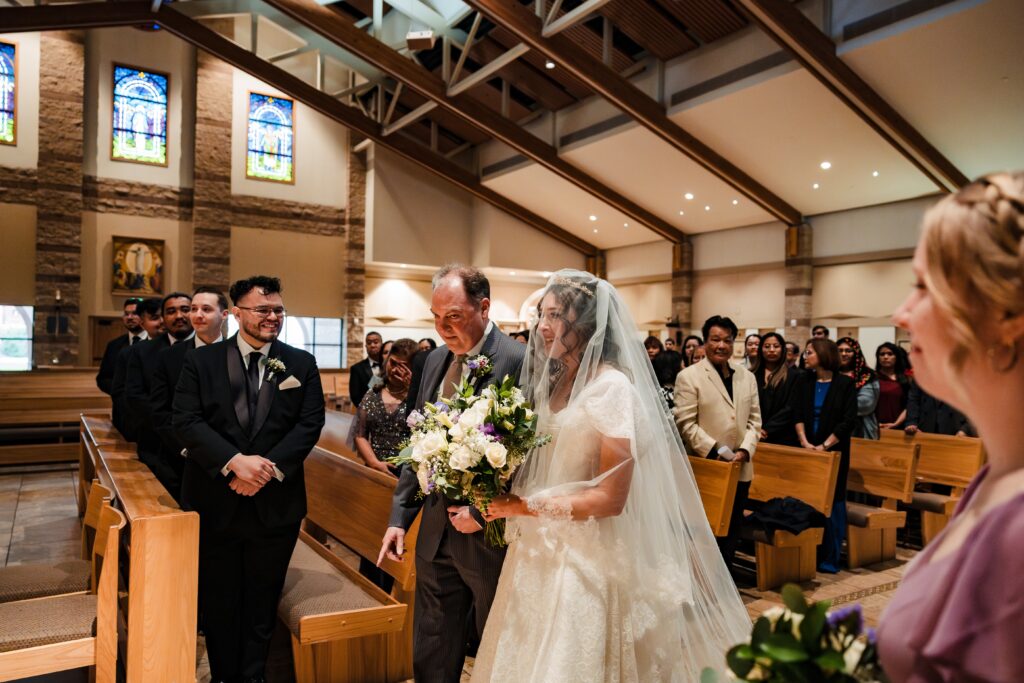 bride walking down the aisle at St Martha's Catholic Parish in Murrieta Ca